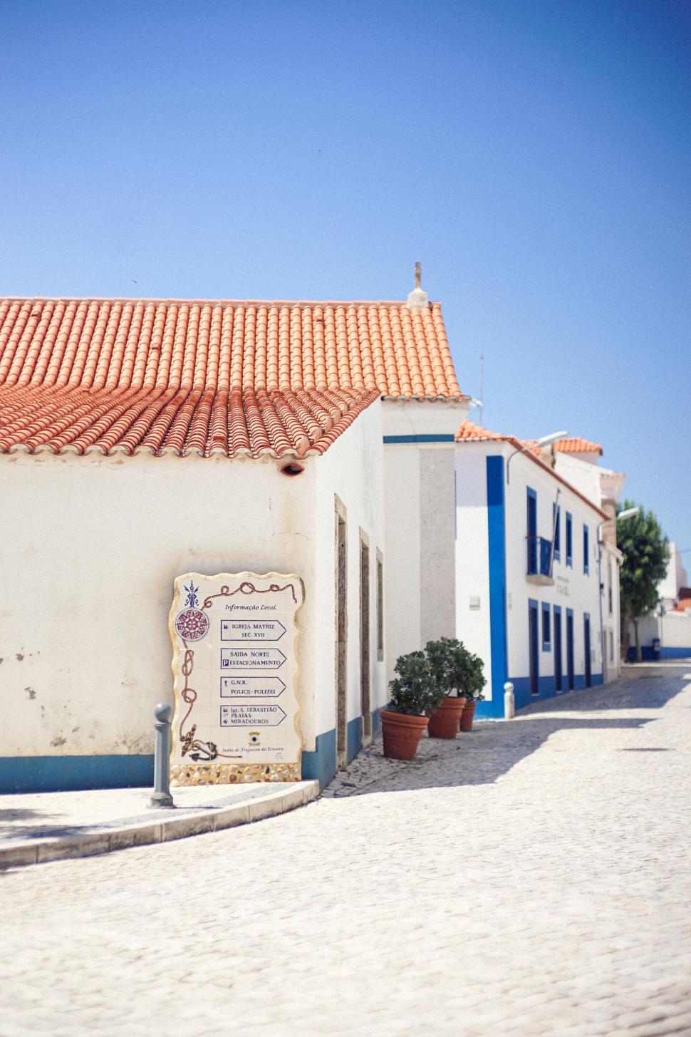 Free Image of Quaint houses on cobblestone street in sunlight 