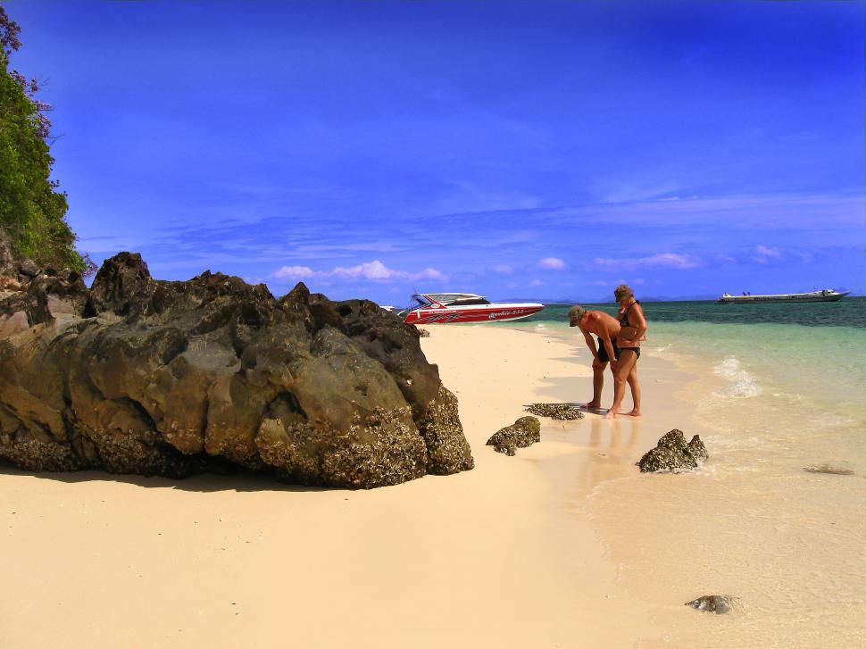 Free Image of Man Standing on Sandy Beach Next to Ocean 