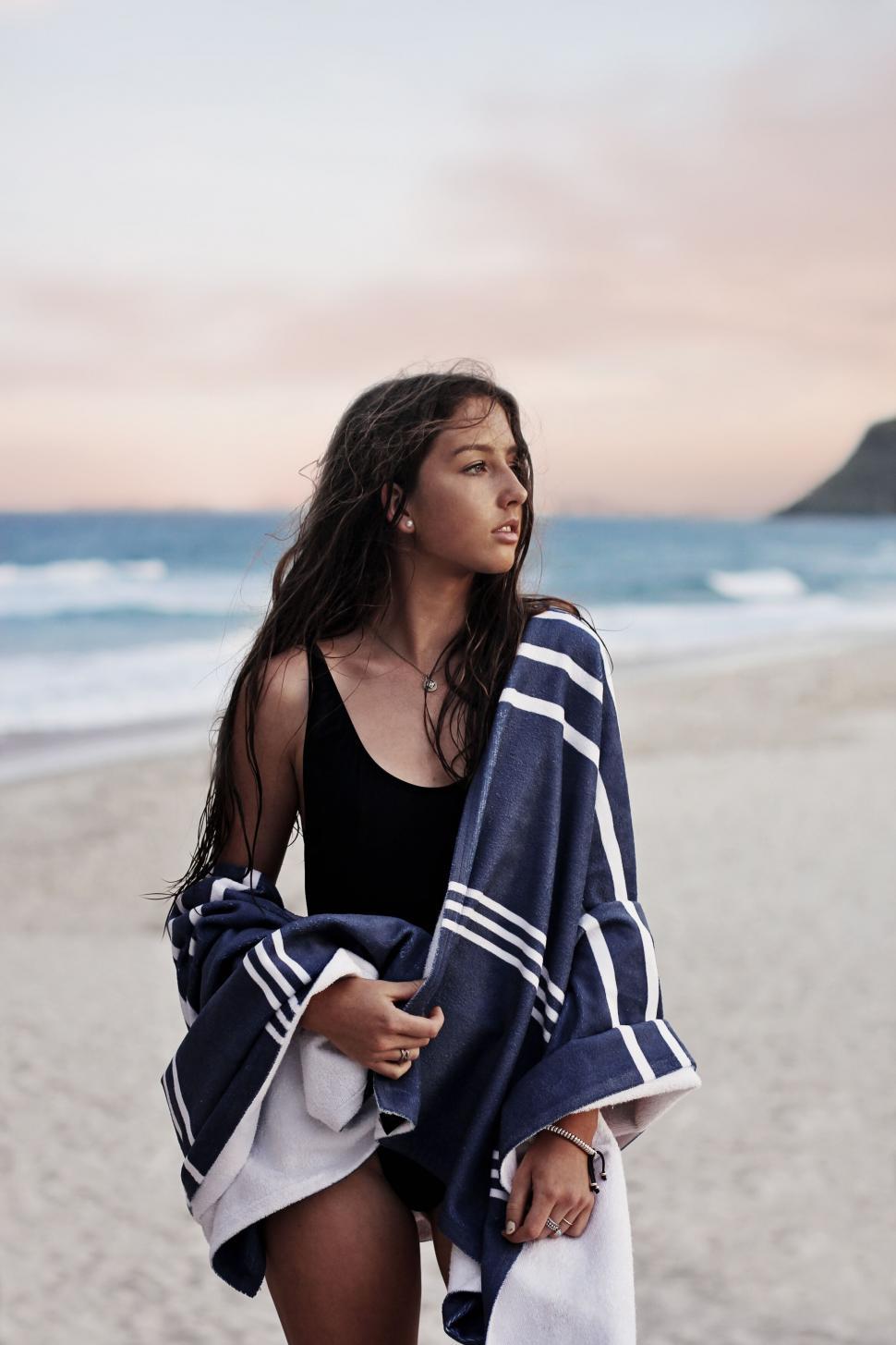 Free Image of Woman wrapped in towel on beach 