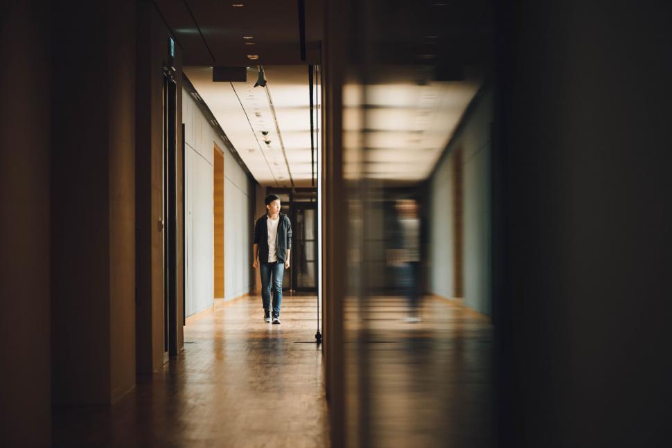 Free Image of Man walking down corridor with natural light 
