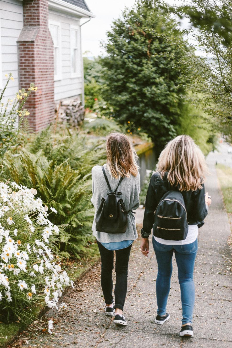 Free Image of Two women walking together along street 