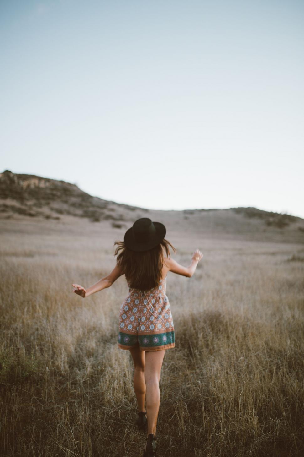 Free Image of Joyful woman running in open field 