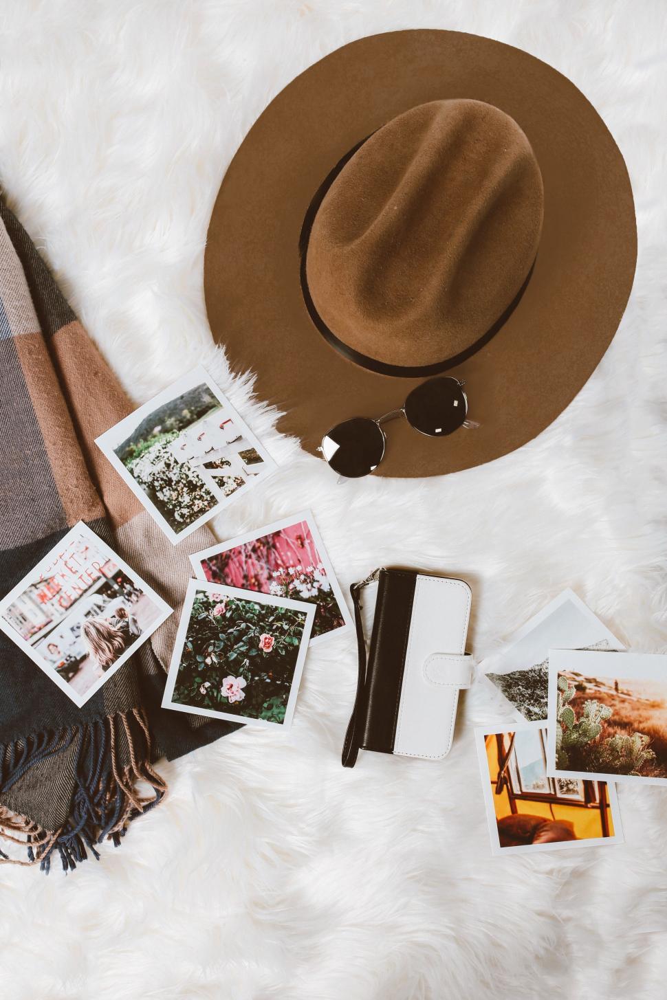 Free Image of Flat lay of cozy lifestyle items with photos 
