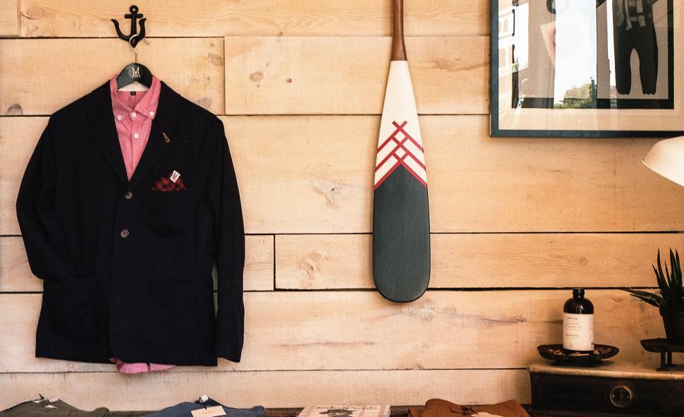 Free Image of Navy blazer on wooden hanger in boutique 