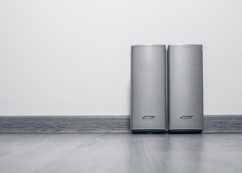Free Image of A pair of Bose speakers on wooden table 