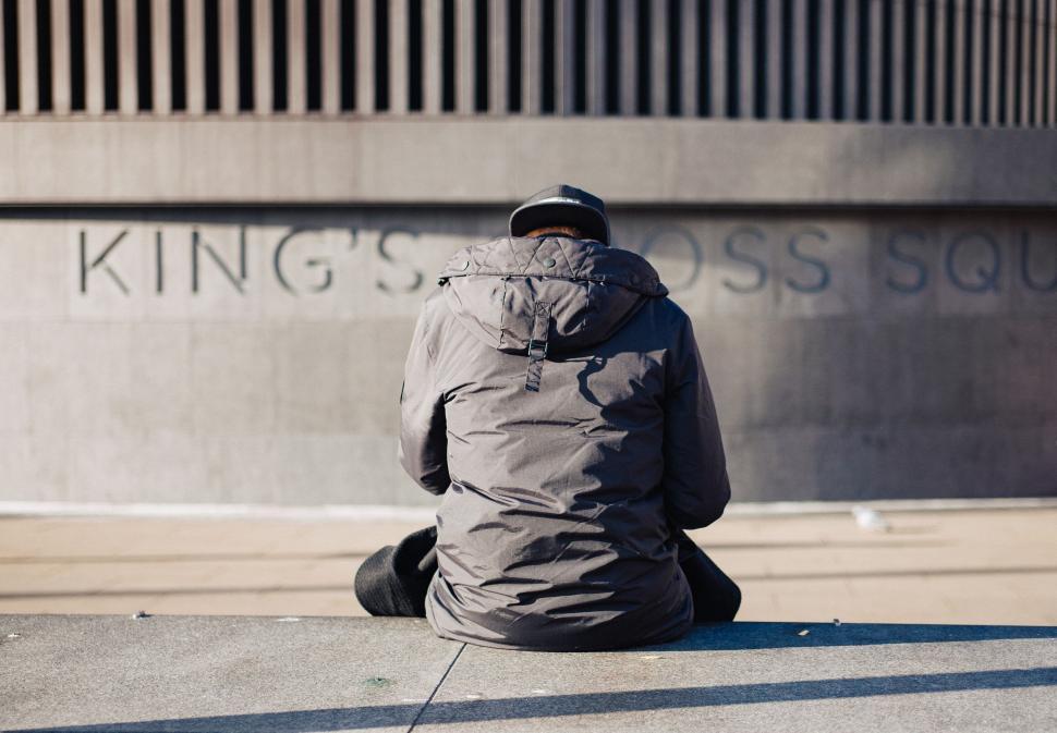 Free Image of Person sitting before King s Cross Square 