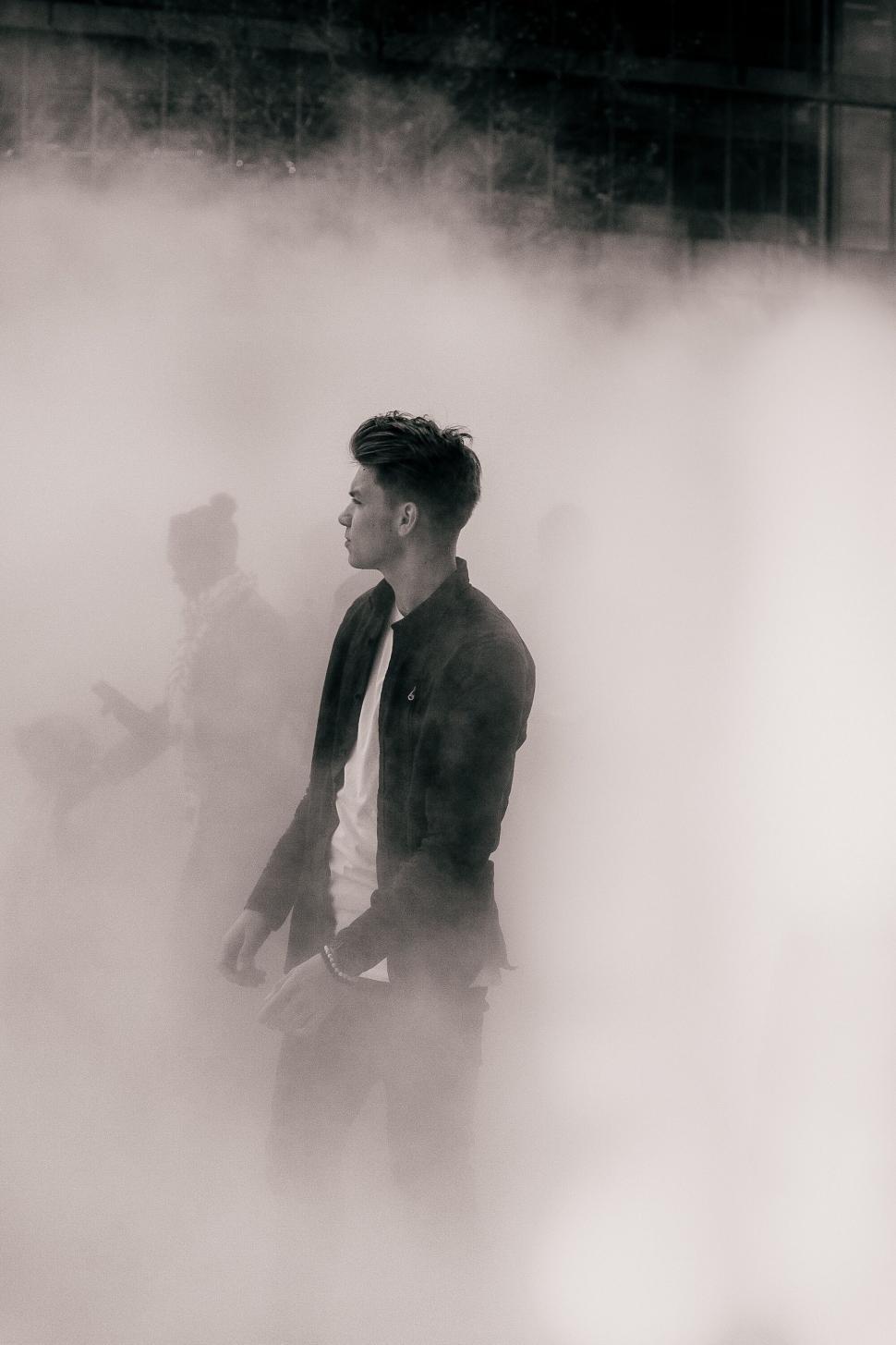 Free Image of Man in fog with outstretched arms 