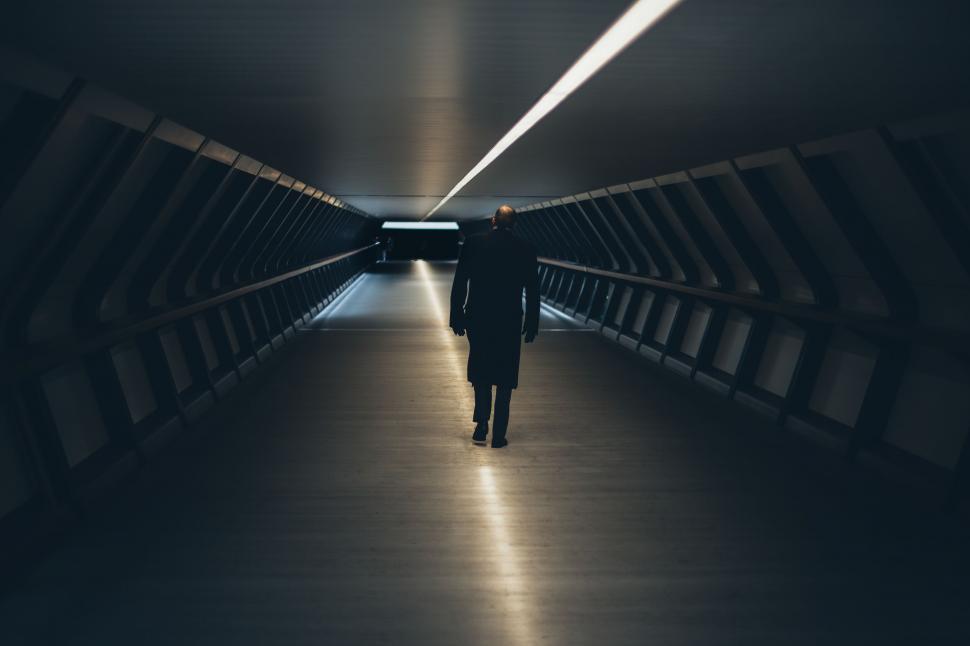 Free Image of Mysterious man walking in futuristic tunnel 
