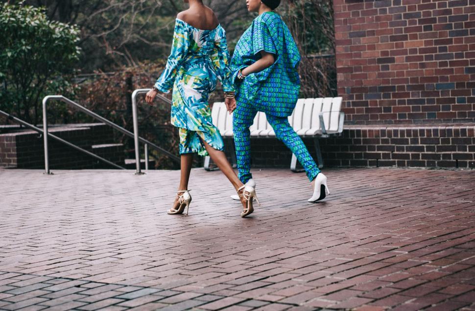 Free Image of Fashionable women strutting in bold outfits 