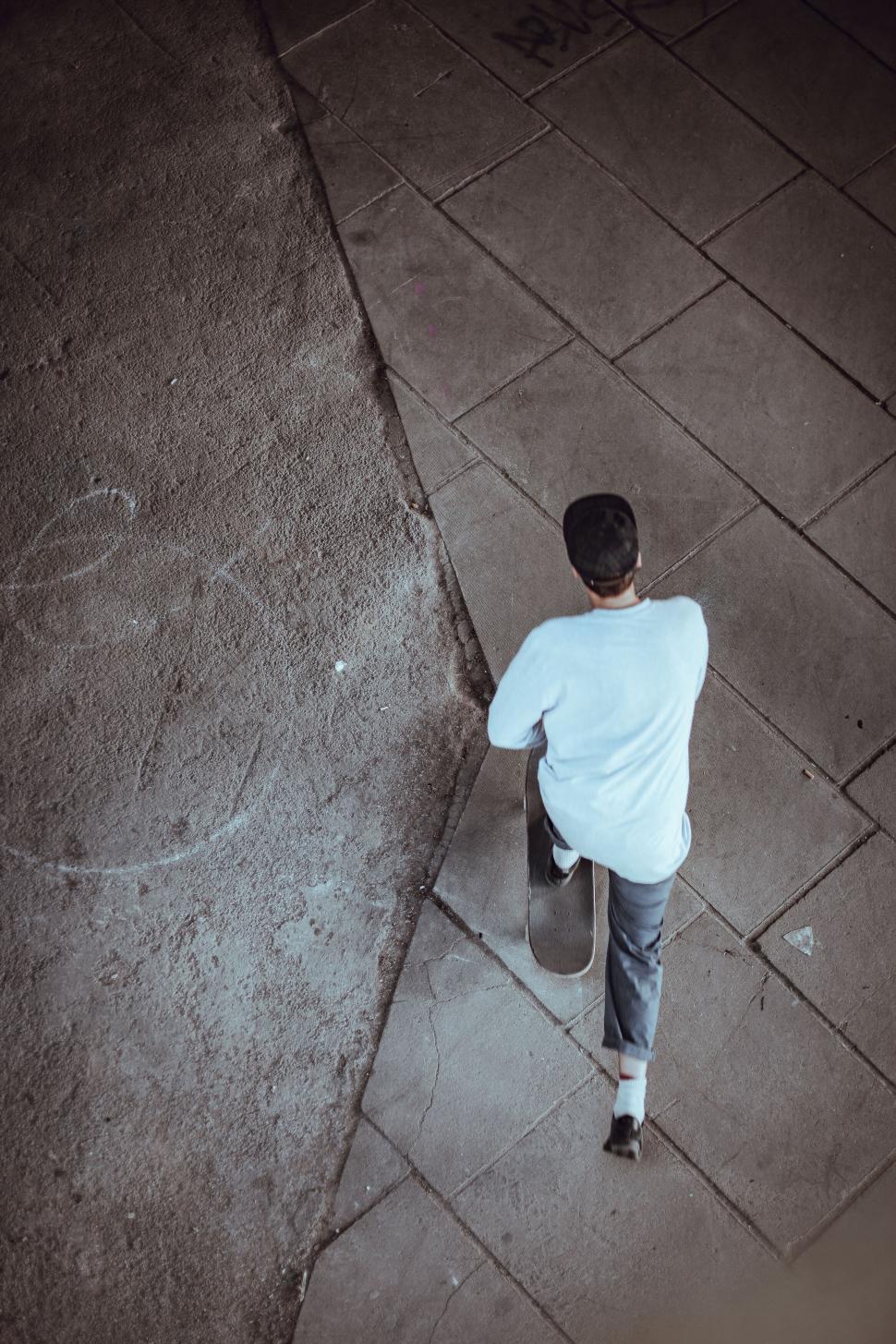 Free Image of Person skateboarding on urban sidewalk 