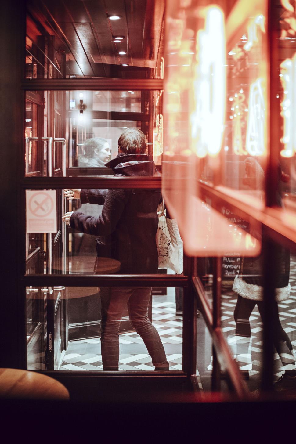 Free Image of Person entering neon-lit venue 