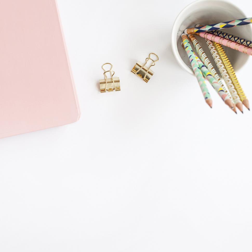 Free Image of Notebook and pencils with workspace items 