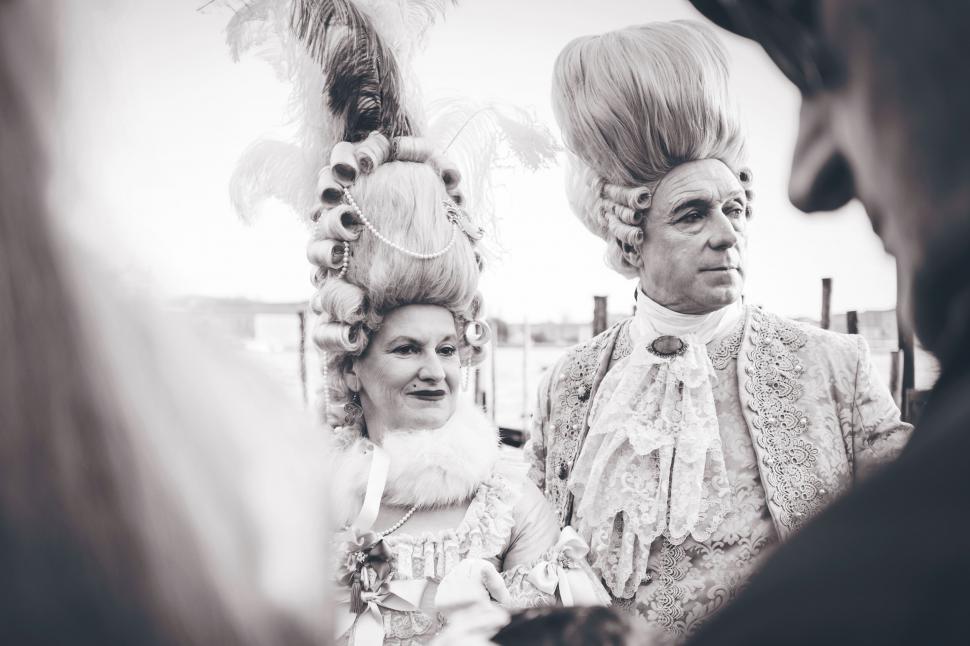 Free Image of People in historical costumes conversing 