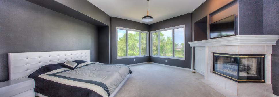 Free Image of Spacious master bedroom with elegant fireplace 