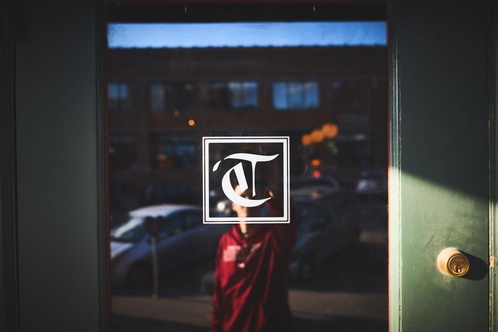Free Image of Mysterious reflection and logo of New York Times 