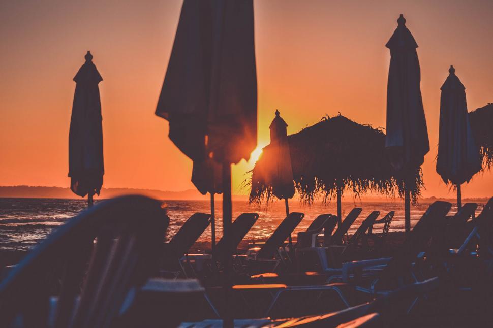 Free Image of Sunset view over beach with umbrellas 