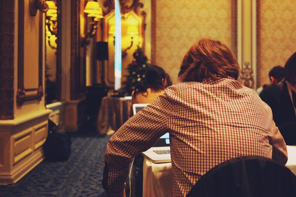 Free Image of Conference attendee engrossed in laptop 
