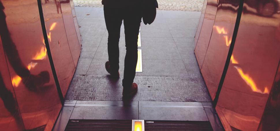 Free Image of Silhouette of a person entering a building 
