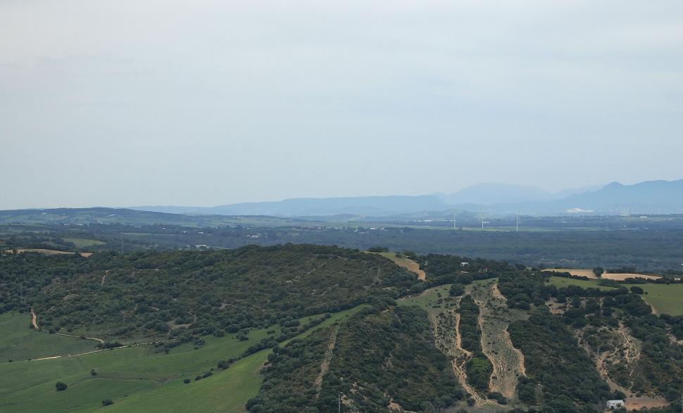 Free Image of Lush green hills under a cloudy sky 