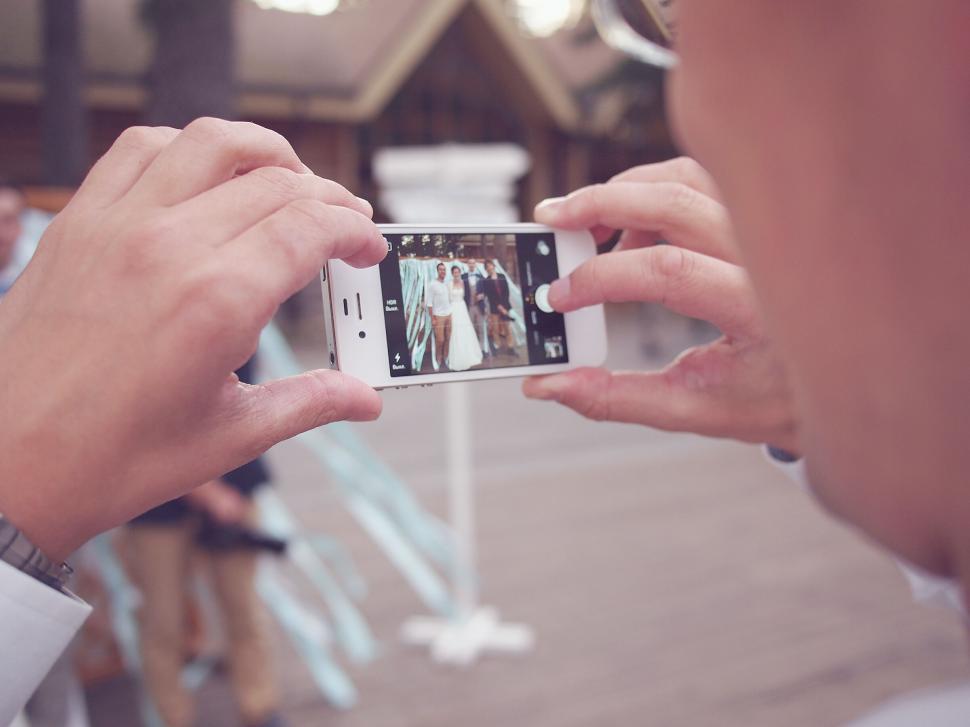 Free Image of Capturing a candid wedding moment on phone 