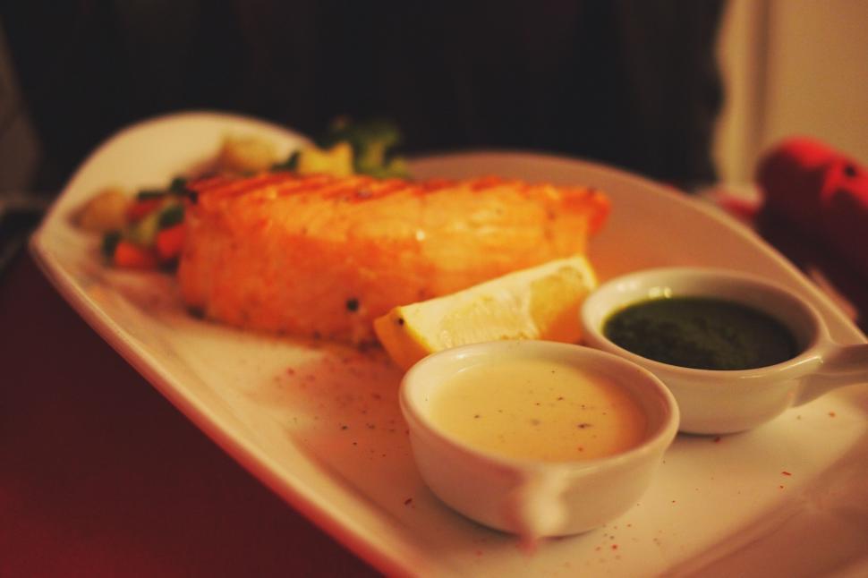 Free Image of Grilled salmon dinner on a plate with sauces 
