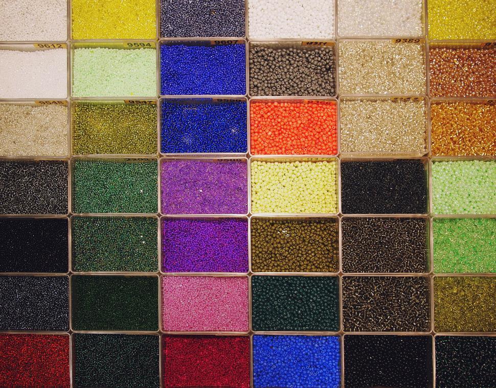 Free Image of Colorful beads in square compartments display 