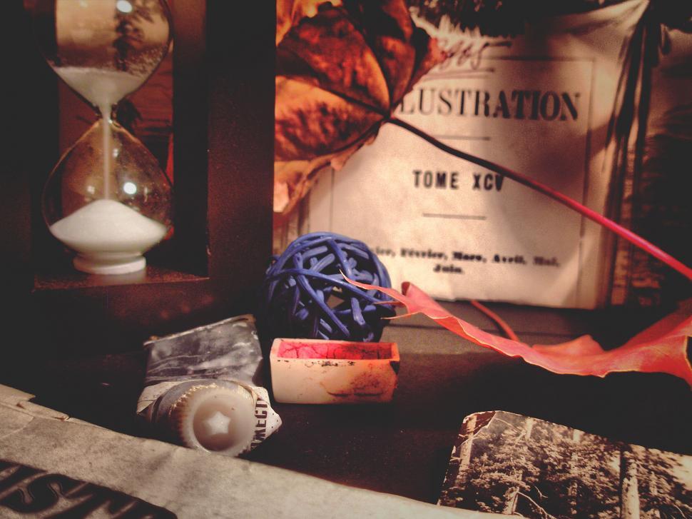Free Image of Vintage items and hourglass on a dusty shelf 
