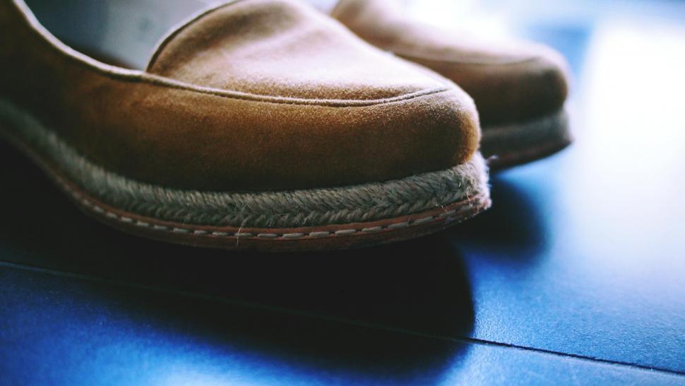 Free Image of Faded suede shoe on a wooden floor 
