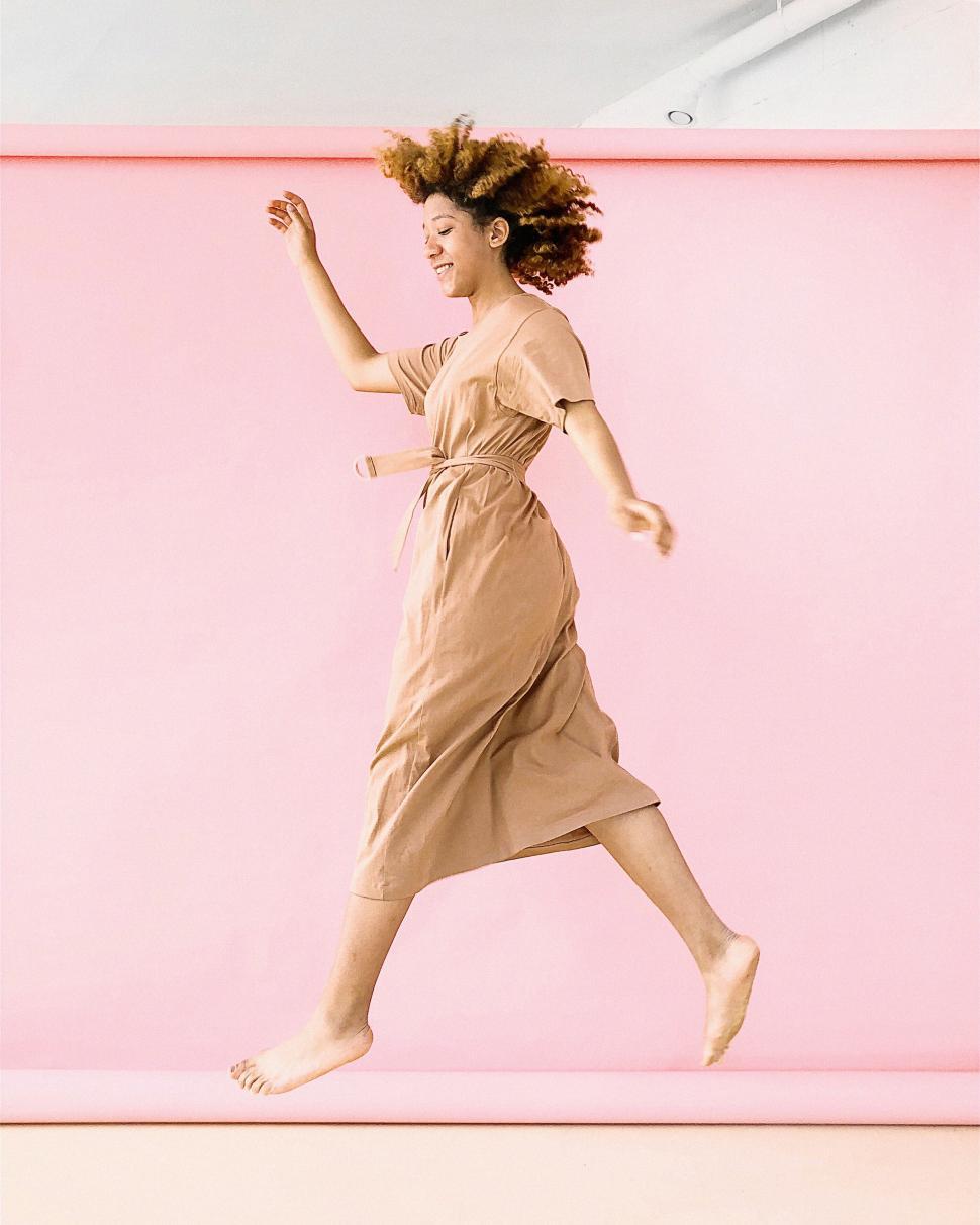 Free Image of Faceless woman in a beige dress 