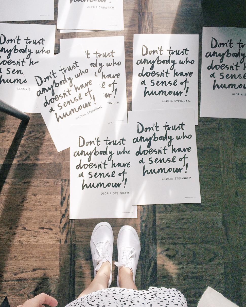 Free Image of Feet and cards with quotes on floor 