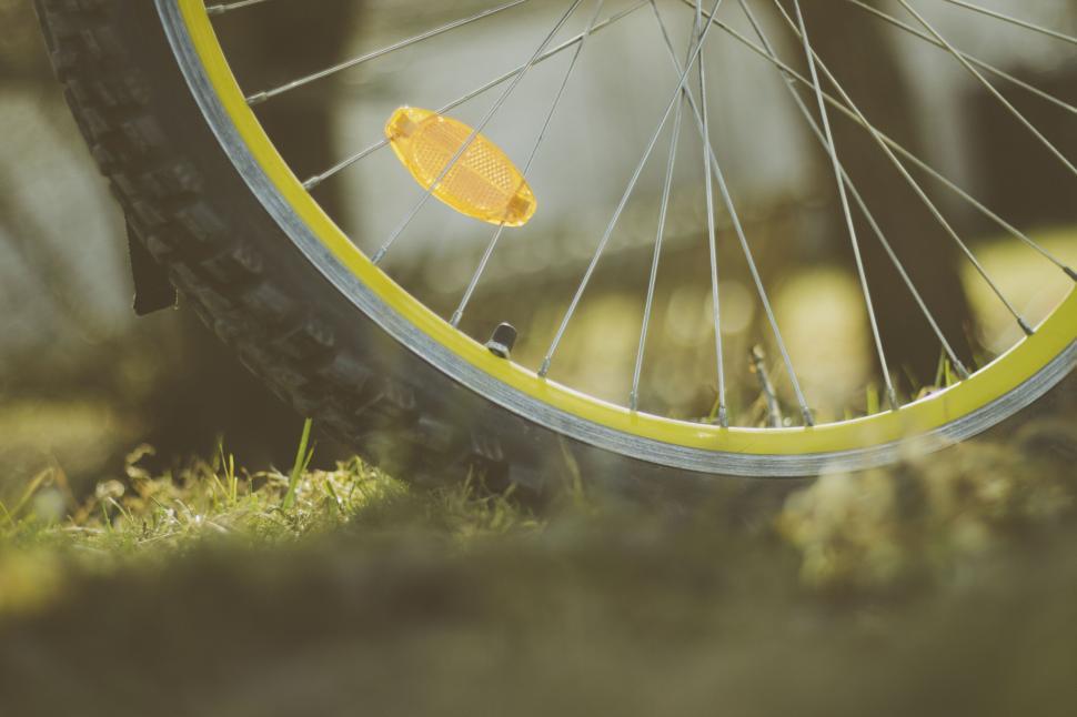 Free Image of Close-up of a bicycle wheel on grass 
