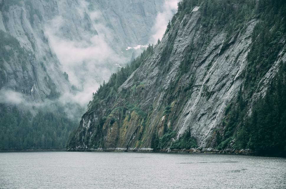 Free Image of Majestic Mountain Cliff by the Water 