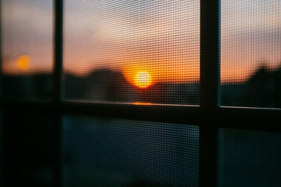 Free Image of Sunset View Behind Mesh Screen 