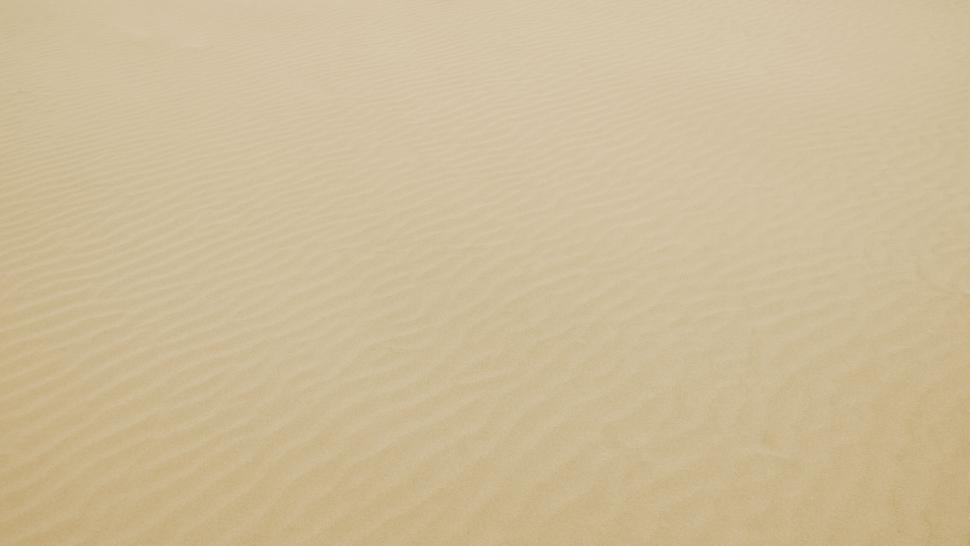 Free Image of Gentle waves pattern on a sandy desert 