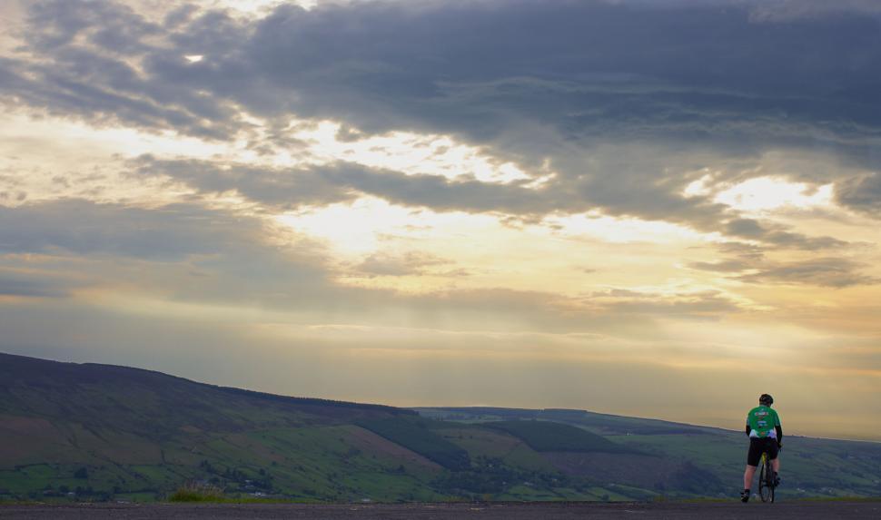 Free Image of Cyclist on a scenic country road at dusk 