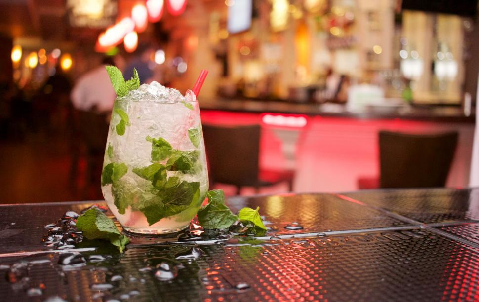 Free Image of Cocktail on outdoor table in busy area 