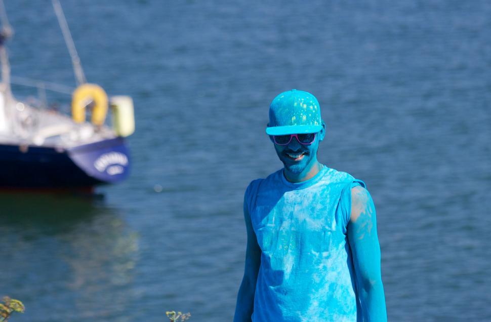 Free Image of Man with blue skin overlooking the harbor 