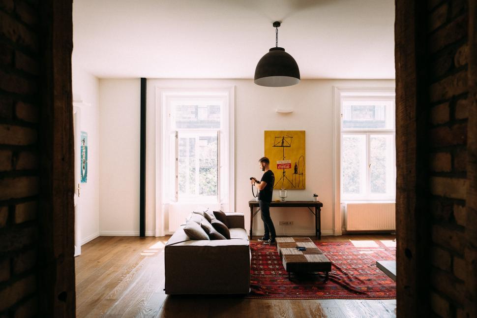 Free Image of Man Standing Next to Couch in Living Room 
