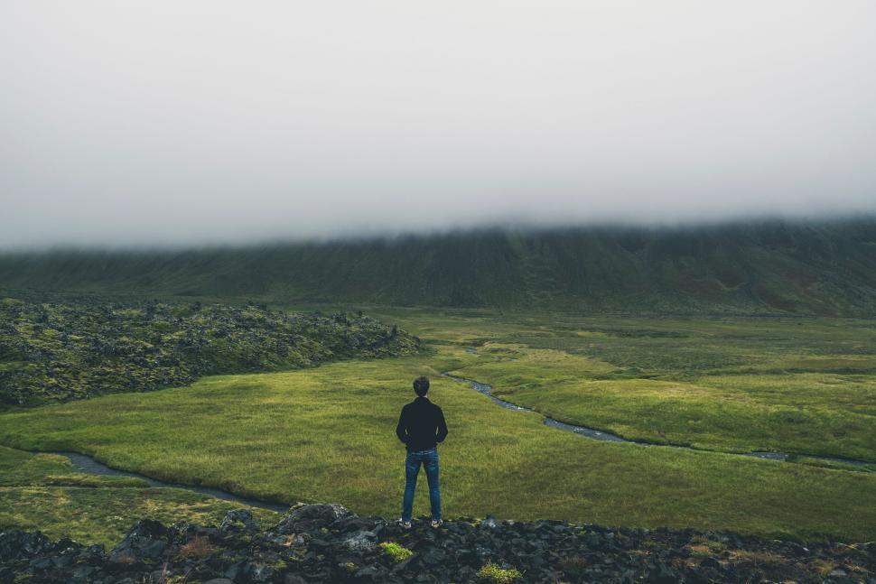 Free Image of Solitary figure amidst vast foggy landscape 