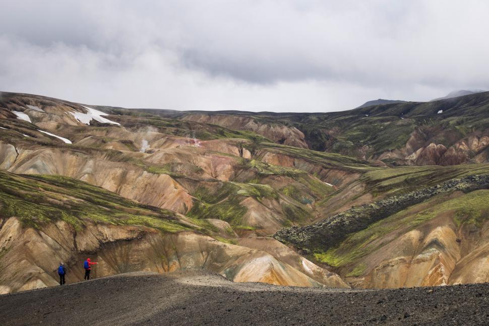 Free Image of Hikers exploring the colorful Rhyolite mountains 