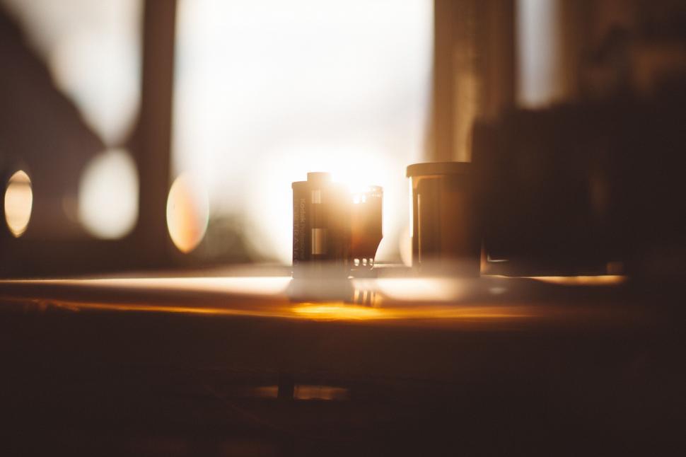 Free Image of Warm sunlight flaring behind film rolls 
