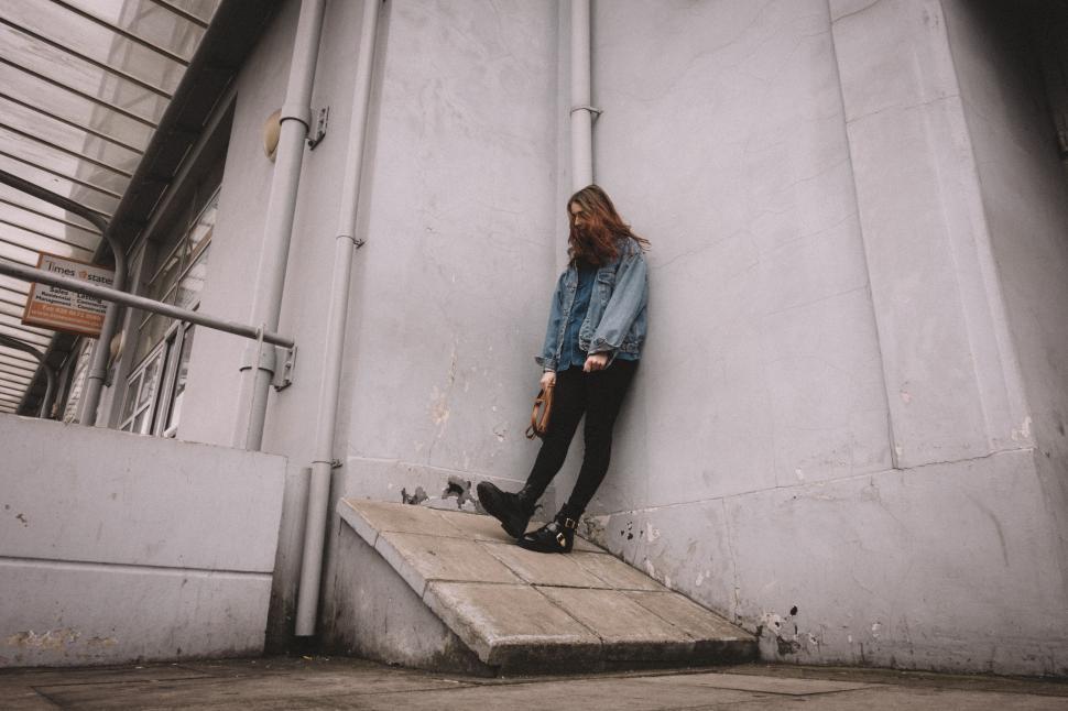 Free Image of Urban scene with a blurred person leaning 