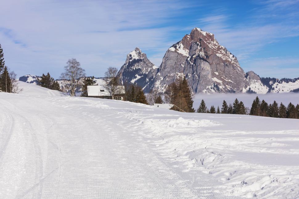 Free Image of Snowy pathway leading towards a majestic mountain peak 