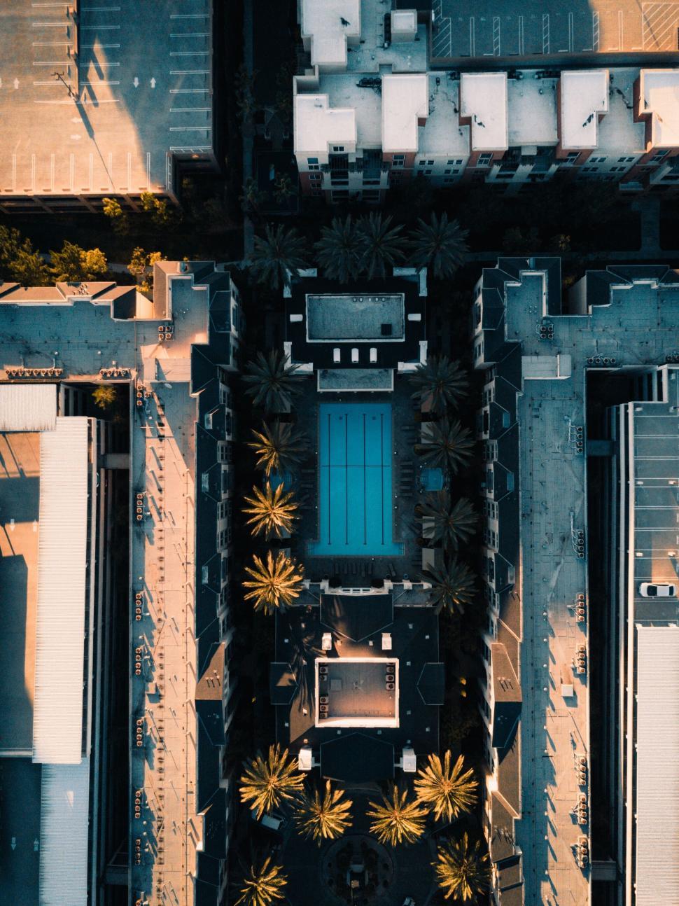 Free Image of Aerial view of a luxurious pool amid buildings 