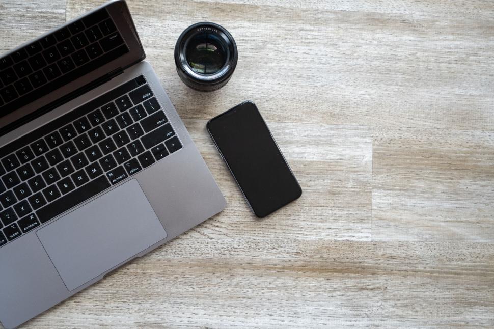 Free Image of Laptop lens and smartphone on wooden floor 