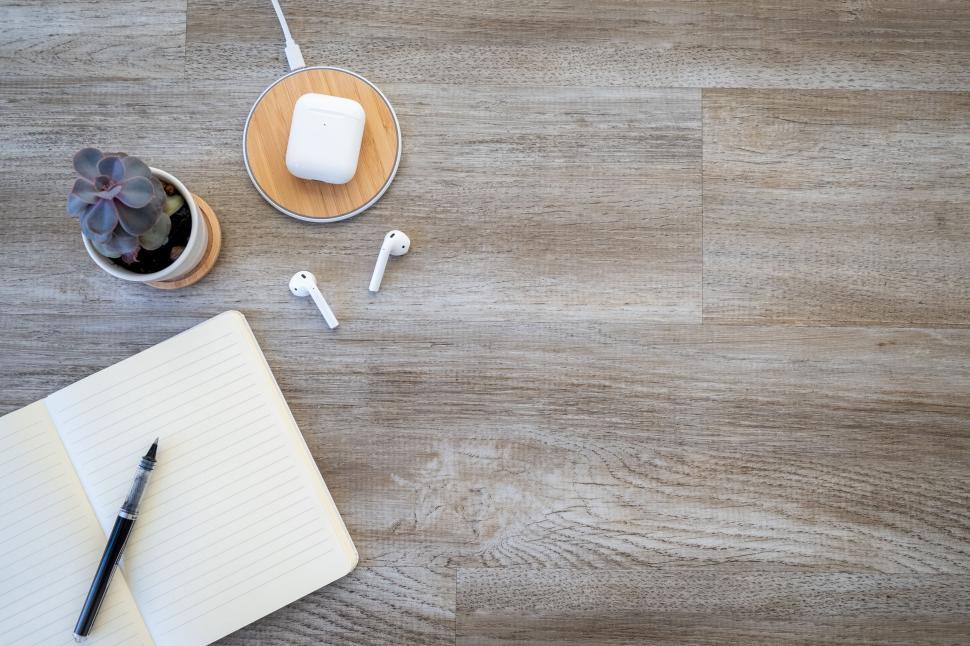 Free Image of Workspace with notebook earphones and plant 