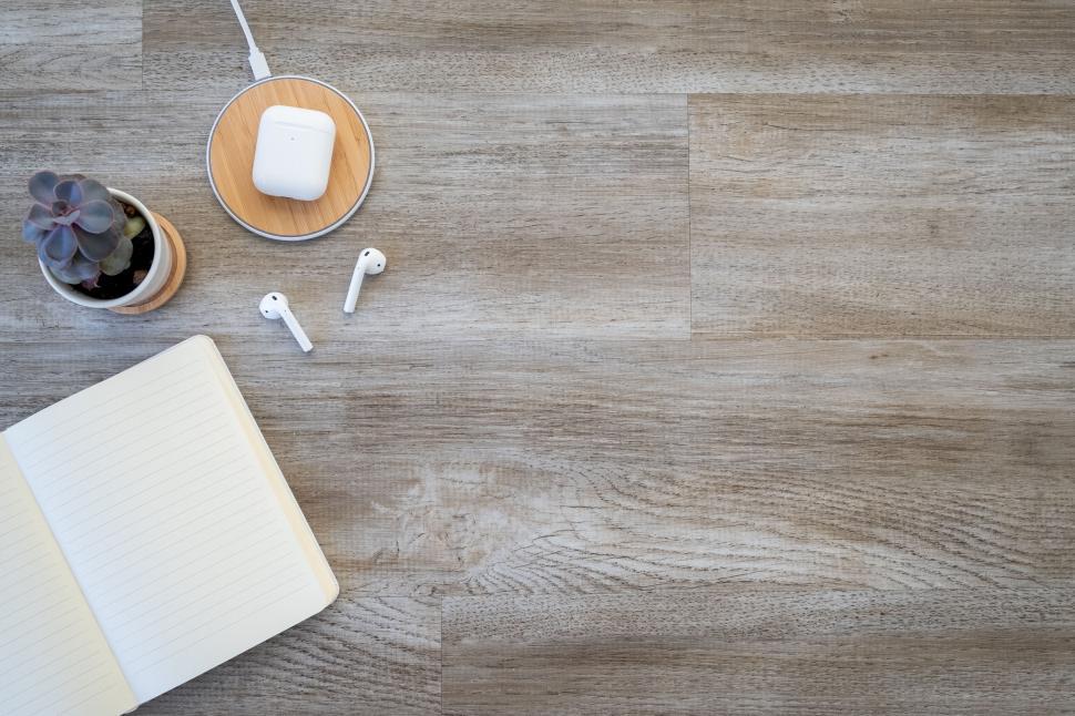 Free Image of Workspace with notebook and Apple AirPods 