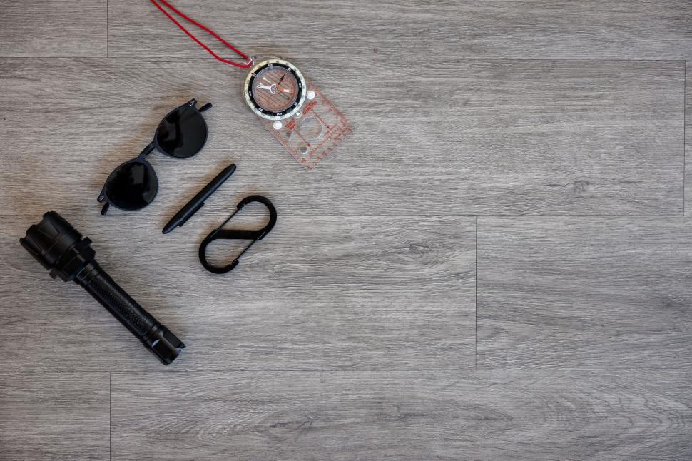 Free Image of Travel essentials with compass on wooden floor 