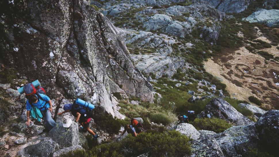 Free Image of Group trekking through rocky mountain area 