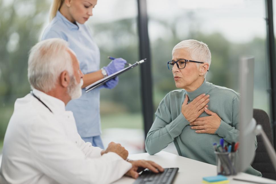 Free Image of Doctor examines patient with throat discomfort 